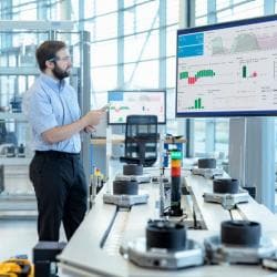 Man standing and analyzing visualized data