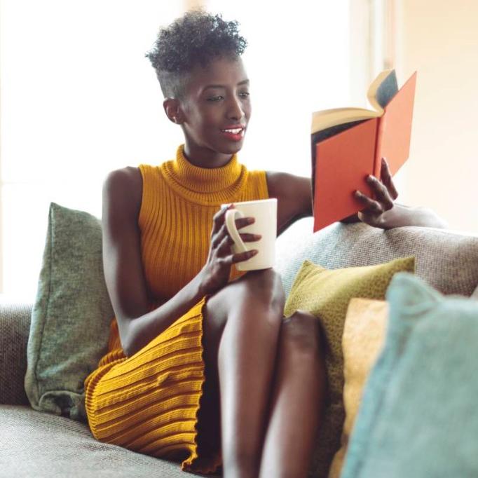 Woman reading a book at home