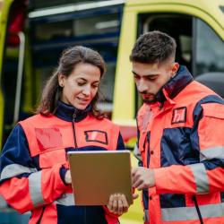 Emergency workers look at clipboard