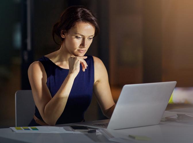 Focused woman looking at the screen of the computer