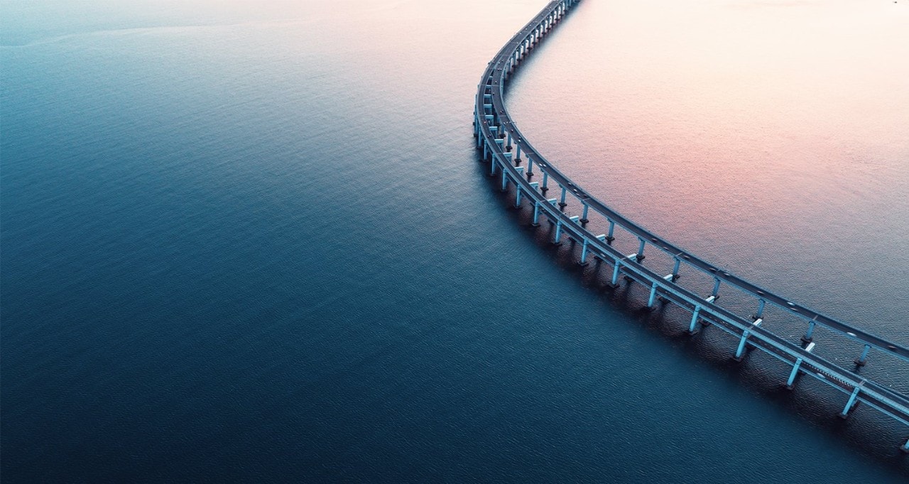 Curved bridge over blue water