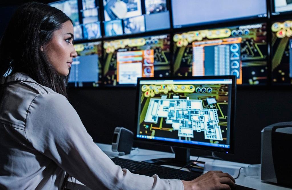 mixed race security guard watching monitors