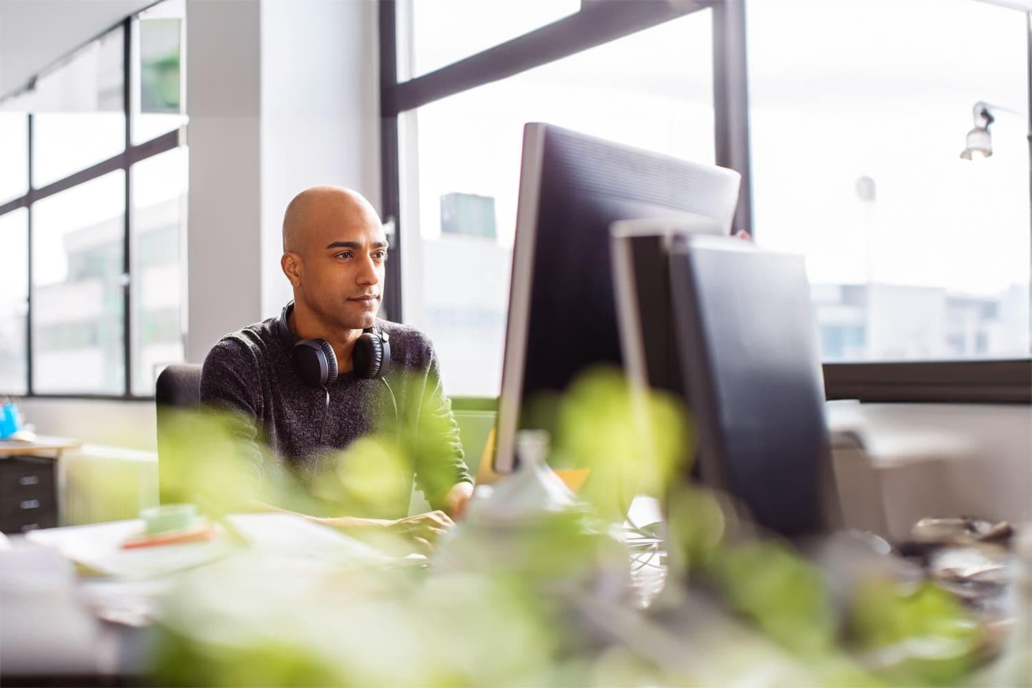 Man sitting at desk looking at computer